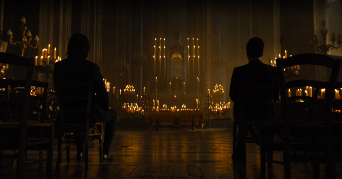 A dark Cathedral with prayer candles.
