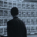 A man staring at rows of windows